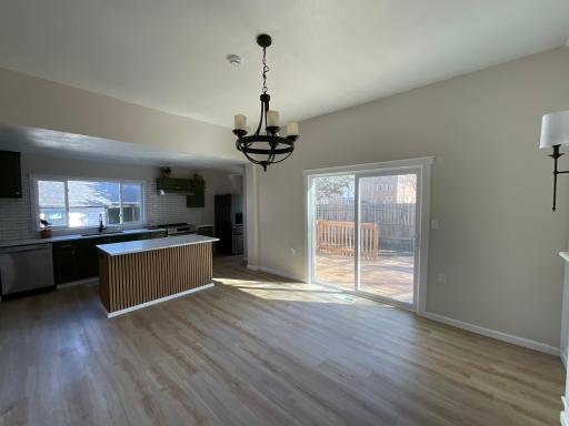 Dining room with view of side entrance sling door unto deck