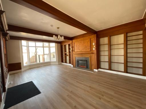 Extensive Great Living Room with Original antique beams and wall shelves with electrical fireplace with brand new bay window