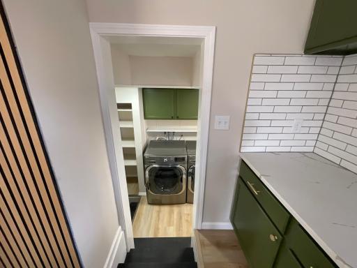 Laundry area looking a few steps from the kitchen where side entrance is located
