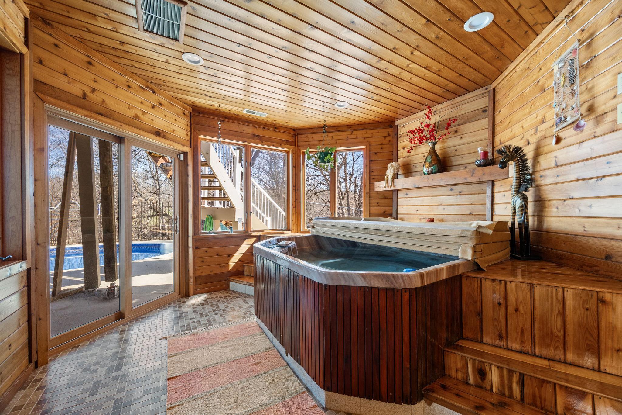 The hot tub room also walks out to the pool.