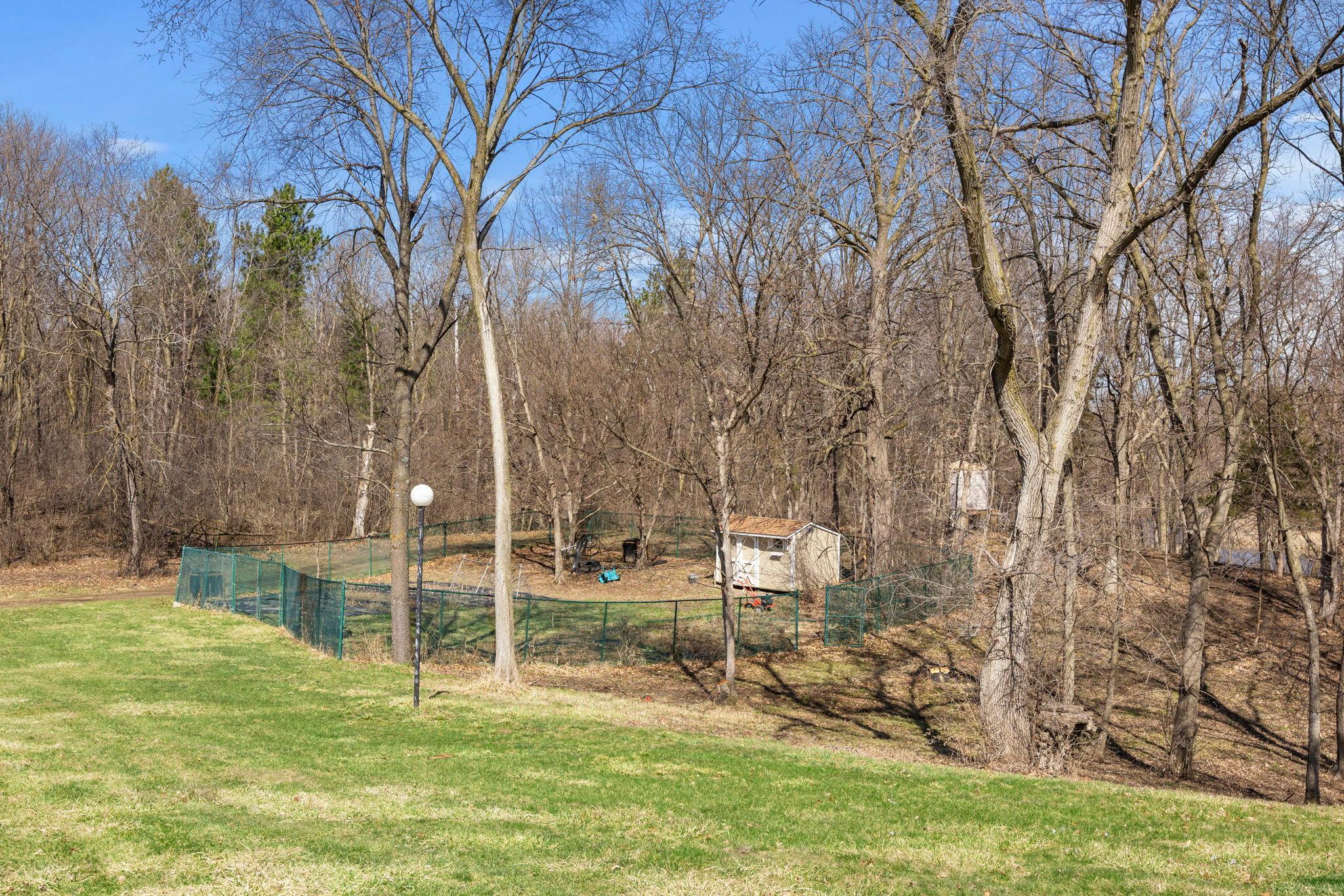 A view of the garden shed and fenced-in vegetable garden.