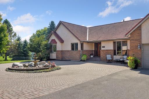 Huge paved drive with paver patio area and fountain.