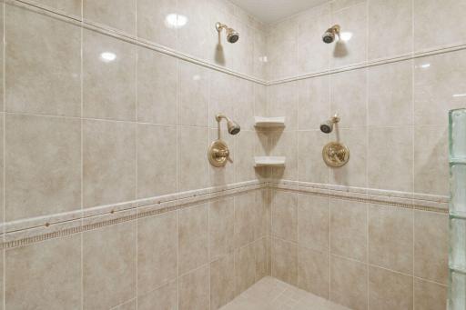 Multiple shower heads in the large lower level shower.