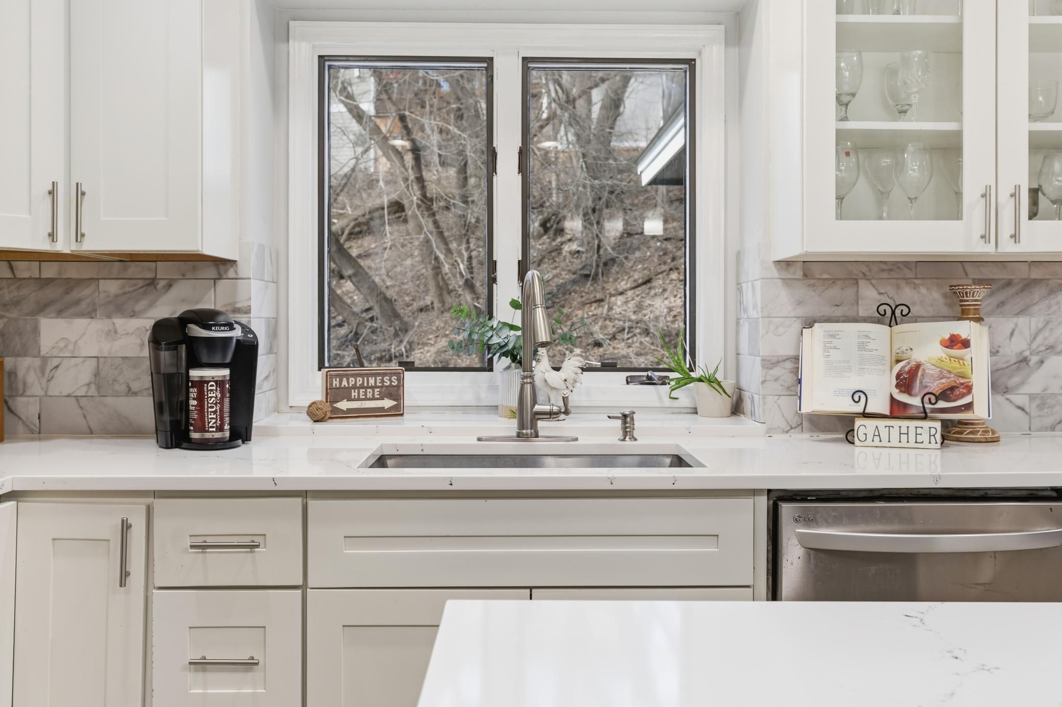 Large undermount sink, huge kitchen window and gleaming countertops - this kitchen is a winner!