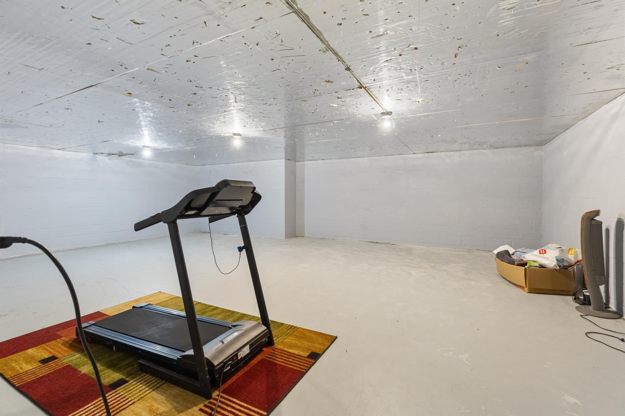 This lower level workshop space can be whatever you want - it could be converted into a theater room, a dedicated exercise room, a photography room or a dream workshop!