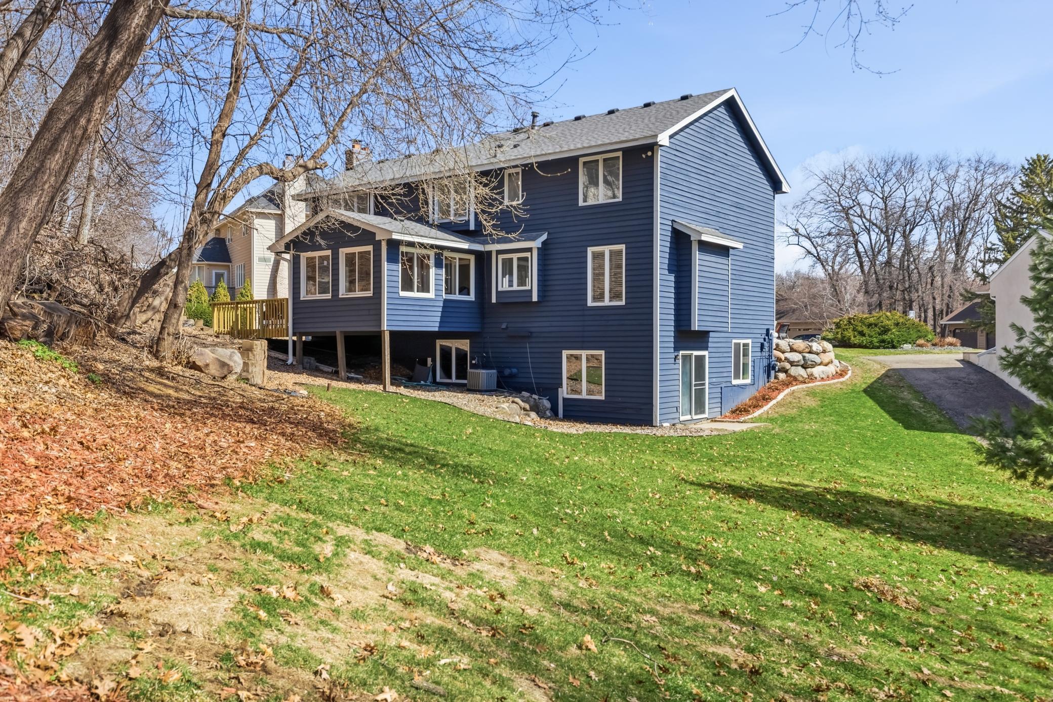 Don't let the brick wall embankment fool you that there's no yard! The lot is so big there is flat side yard in addtion to your large front yard for space!