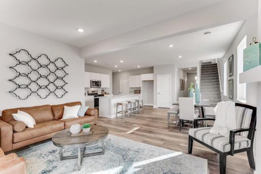 Open concept main floor, easily accessing the kitchen, living, and dining spaces.