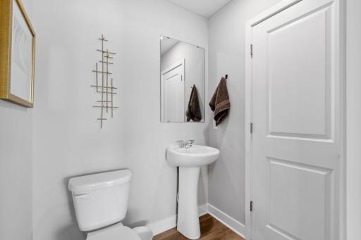 Convenient half bath situated on the main level. Photo is of model home. Colors and options may vary. Ask Sales Agent for details.