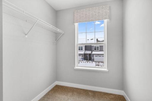 Bedroom 2 gets it's own large walk-in closet with a window! Photo is of model home. Colors and options may vary. Ask Sales Agent for details.