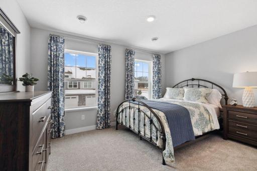 Tucked away from the hustle and bustle of the main level living spaces, this bedroom resides adjacent to a full bath and serves as the perfect guest room or your home office! Photo is of model home.
