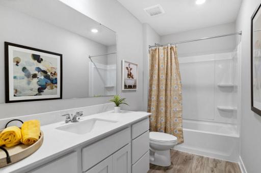 Upper level hall bath serves the secondary bedrooms. Photo of Model Home. Options and colors may vary. Ask Sales Agent for details.