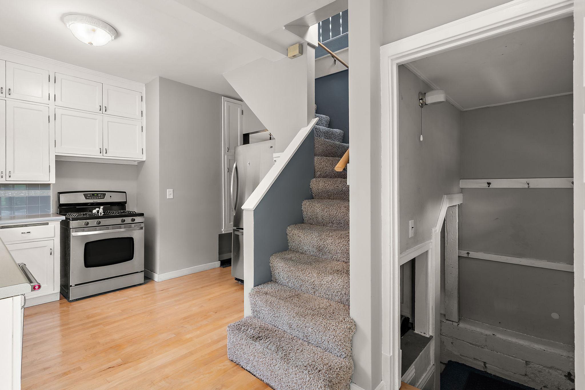 The stairs to the 2nd floor & access to the back door are in the kitchen.