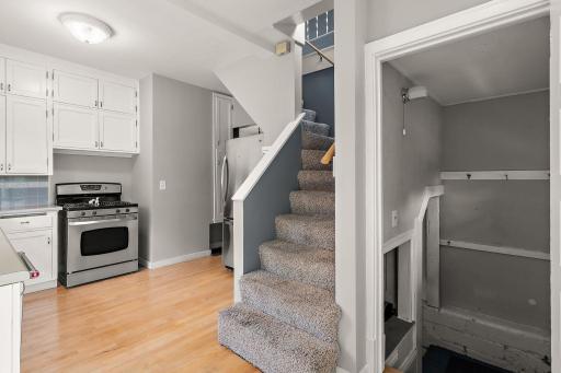 The stairs to the 2nd floor & access to the back door are in the kitchen.