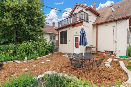 The no mow back yard has fresh mulch to keep the weeds at bay & beautiful stone walking paths & retaining walls.