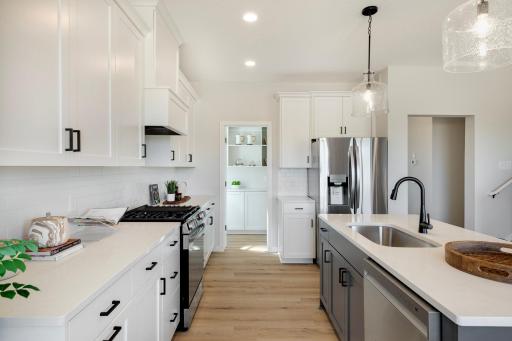 Step right into the morning kitchen, a thoughtfully designed pantry that combines organization & functionality. Photos are from previously built home; options and features may vary.
