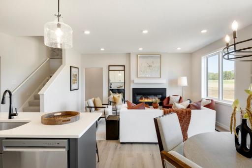 This home features a stunning open-concept design that seamlessly connects the family room, kitchen, and dining area, creating an ideal space for both daily living and entertaining. Photos are from previously built home; options and features may vary