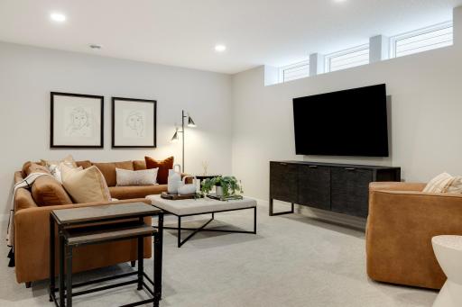 This beautifully finished lower level offers a versatile living space, perfect for additional family gatherings, guests, or relaxation. Photos are from previously built home; options and features may vary.