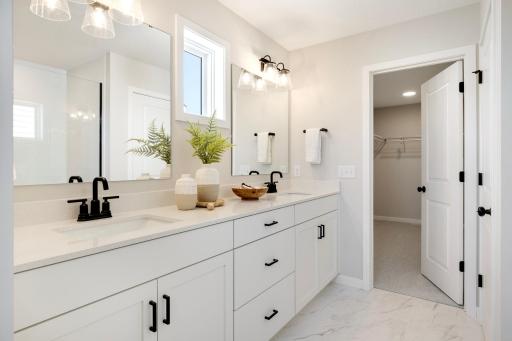 The double sink vanity in the primary bath offers both convenience and style, making it the perfect feature for busy mornings or shared spaces. Photos are from previously built home; options and features may vary.