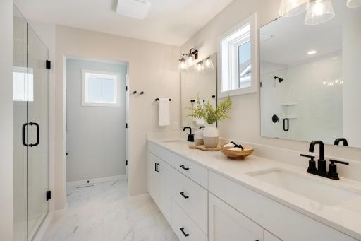 The double sink vanity in the primary bath offers both convenience and style, making it the perfect feature for busy mornings or shared spaces. Photos are from previously built home; options and features may vary.