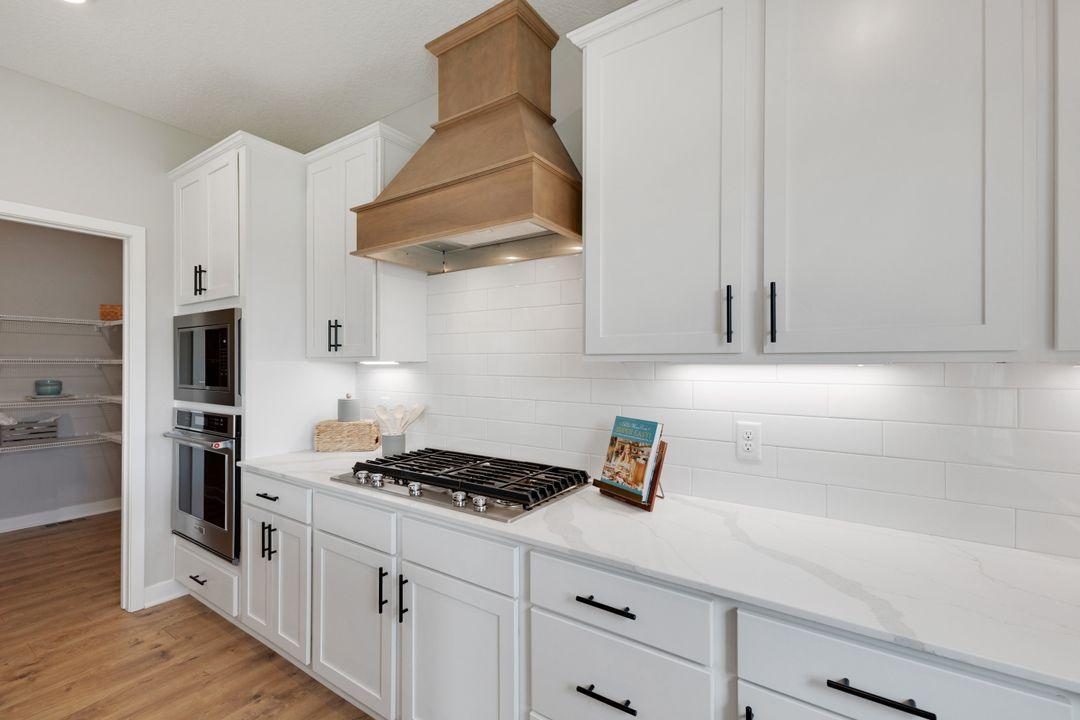 Beautiful wood hood is one of the main focuses of this Gourmet kitchen.