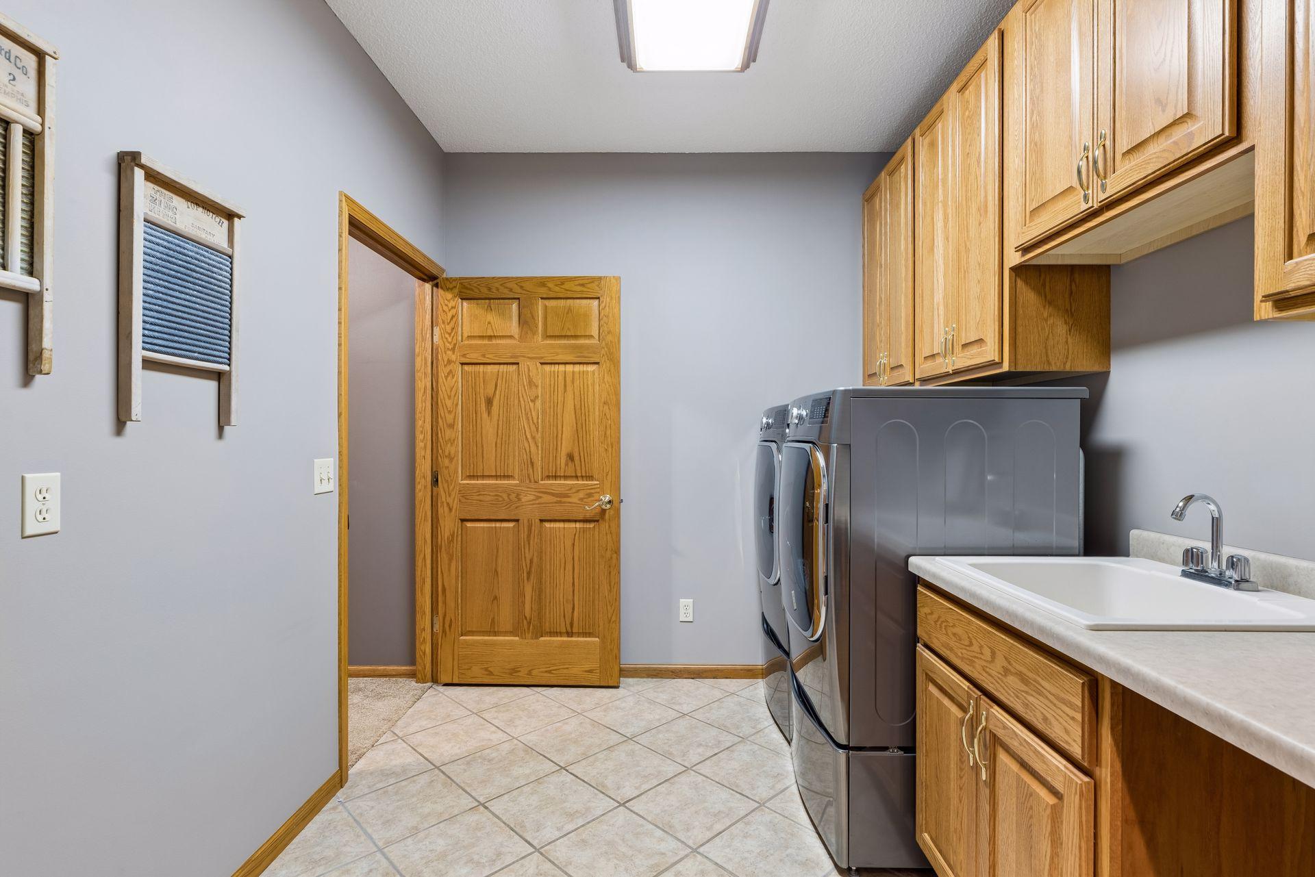 Laundry room with sink and plenty of cabinets