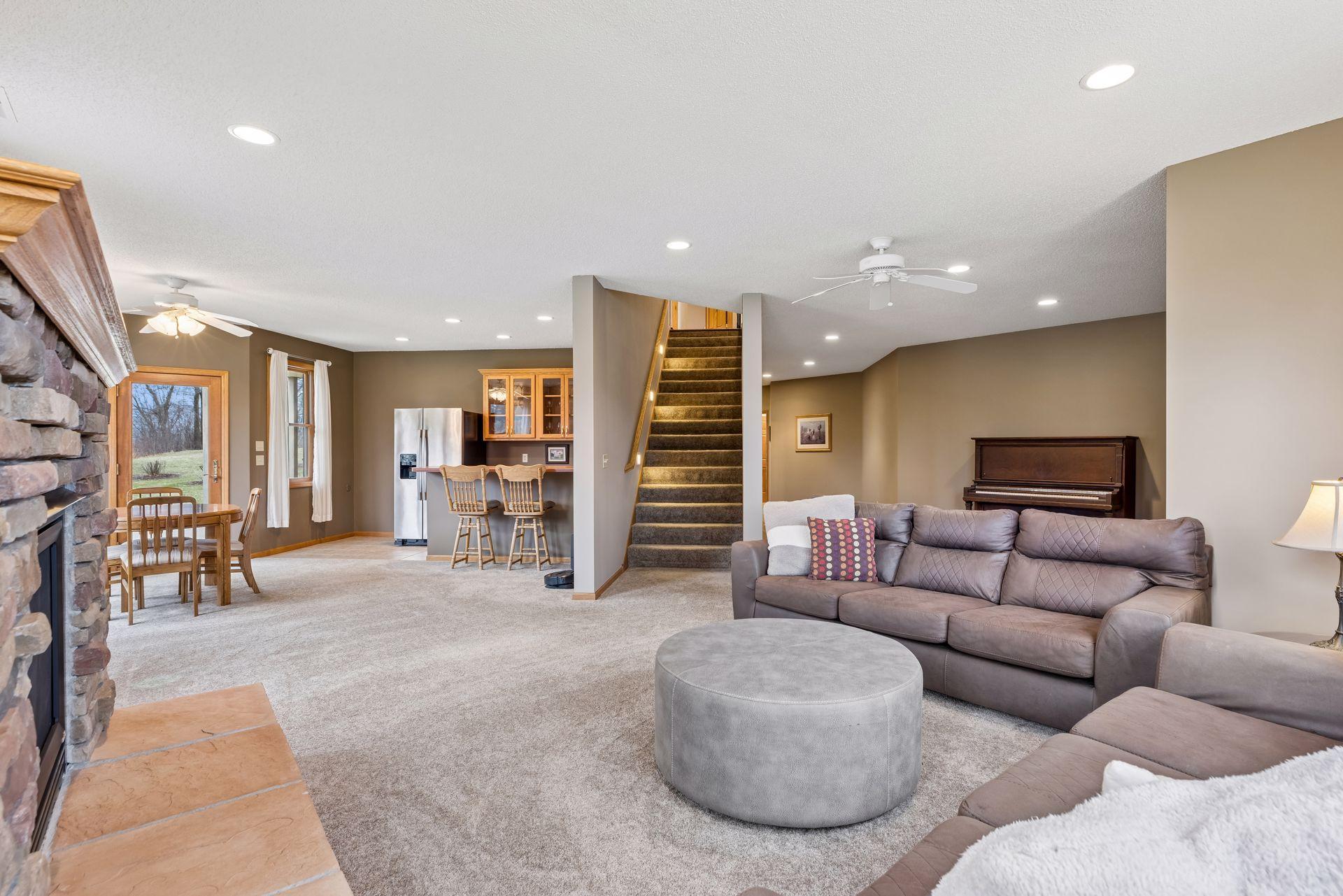 Lower-level family room features an adjacent informal dining and wet bar
