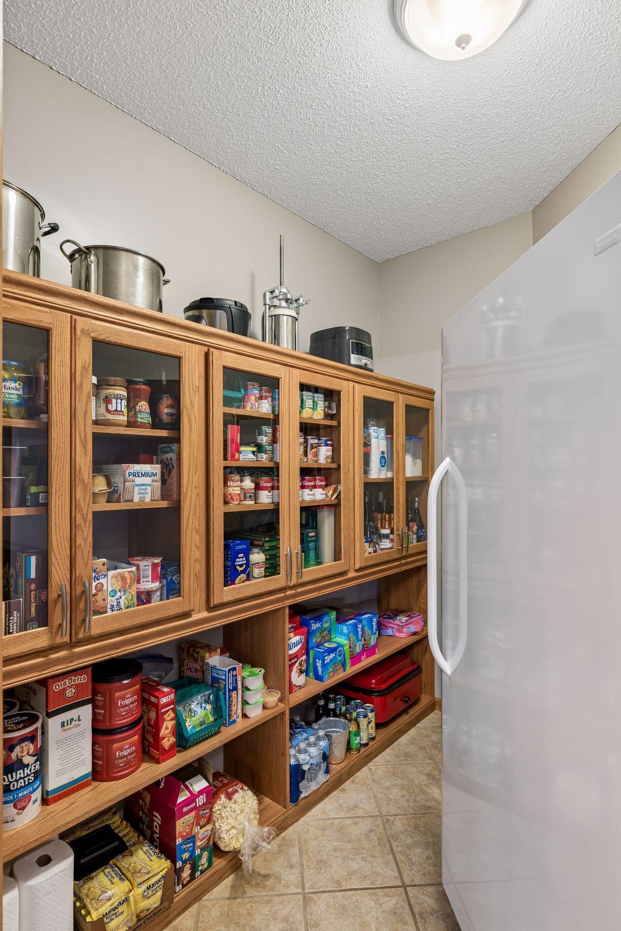 Huge pantry closet in the kitchen with large freezer and tons of storage for all your kitchen appliances