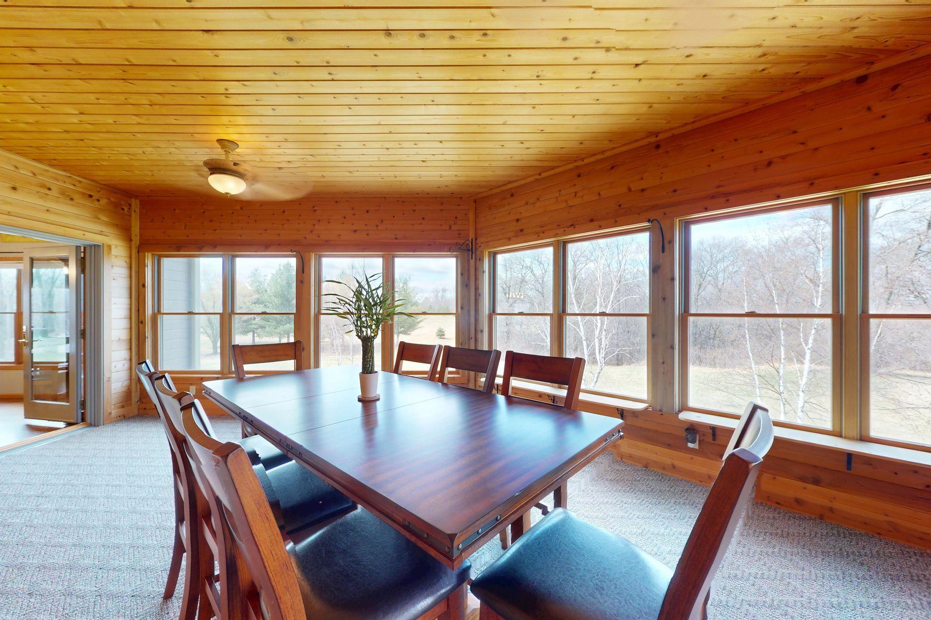 3-season porch adjacent from kitchen and dining room, unique angles pulling light from all angles
