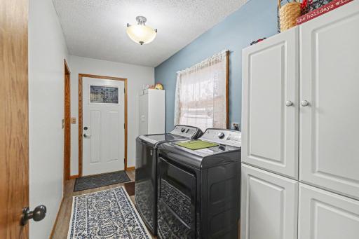 Convenient main floor laundry with extra storage cabinets! Everyone loves main floor laundry!