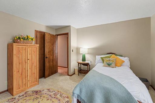 NW bedroom is carpeted with walk in closet.