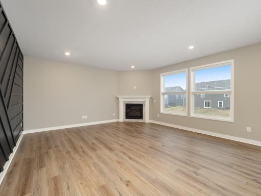 Nice living room space complete with gas fireplace and large windows overlooking the backyard.