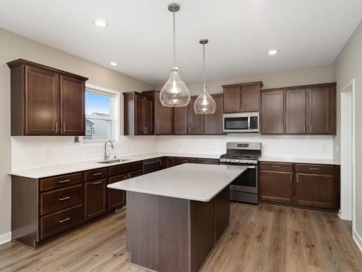 Add a couple of stools to the center island and expand the seating capacity.