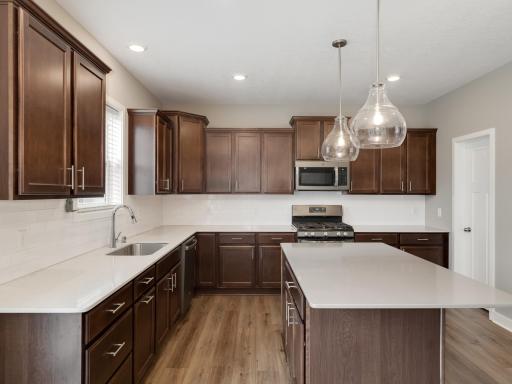 Very nice kitchen design with lots of work surfaces to choose from.