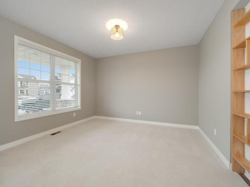 The flex room is the first room you will see as you enter the home. Could be a home office, library or easily converted to a future 5th bedroom. The bookcase to the right is easily removable.