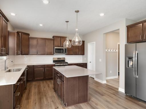 There is a pantry in the back right corner next to the doorway leading to the mudroom closet. Short distance from the garage to the kitchen making access on grocery day easy.