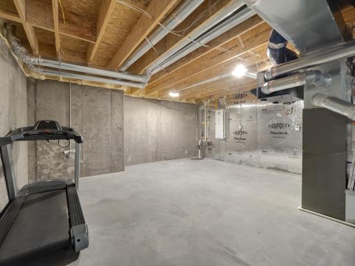 As you come down the steps, this part of the basement would make an excellent storage room. You can easily see the poured concrete walls, sump pump and technology panel in the background.
