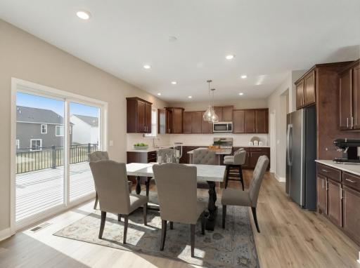 Virtually staged - The dining room is centrally located between the living room, kitchen and rear deck. Perfect for smaller family meals or extend outwards for those larger gatherings.