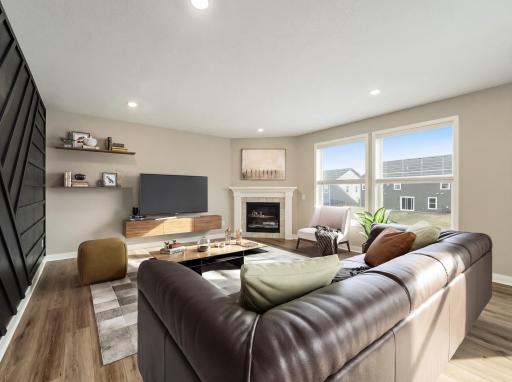 Virtually staged - Nice living room space complete with gas fireplace and large windows overlooking the backyard.