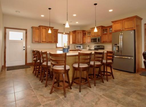You will love this amazing kitchen with high end stainless appliances, ample maple cabinetry, huge island that seats six, and beautiful tile flooring with in-floor heat!