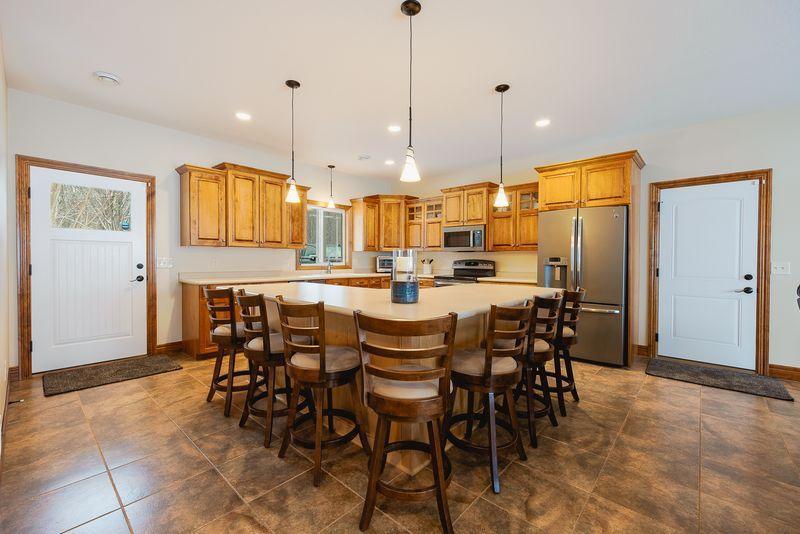 You will love this amazing kitchen with high end stainless appliances, ample maple cabinetry, huge island that seats six, and beautiful tile flooring with in floor heat.