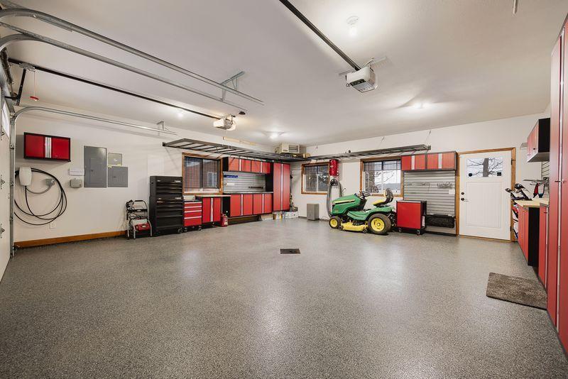 Nicely organized garage with epoxy flooring and floor drain.