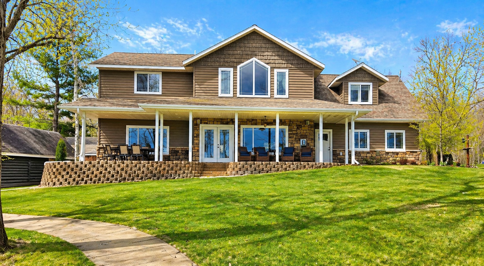 This is the view of this amazing home from the lake. Large windows enhance lake views from throughout the home.