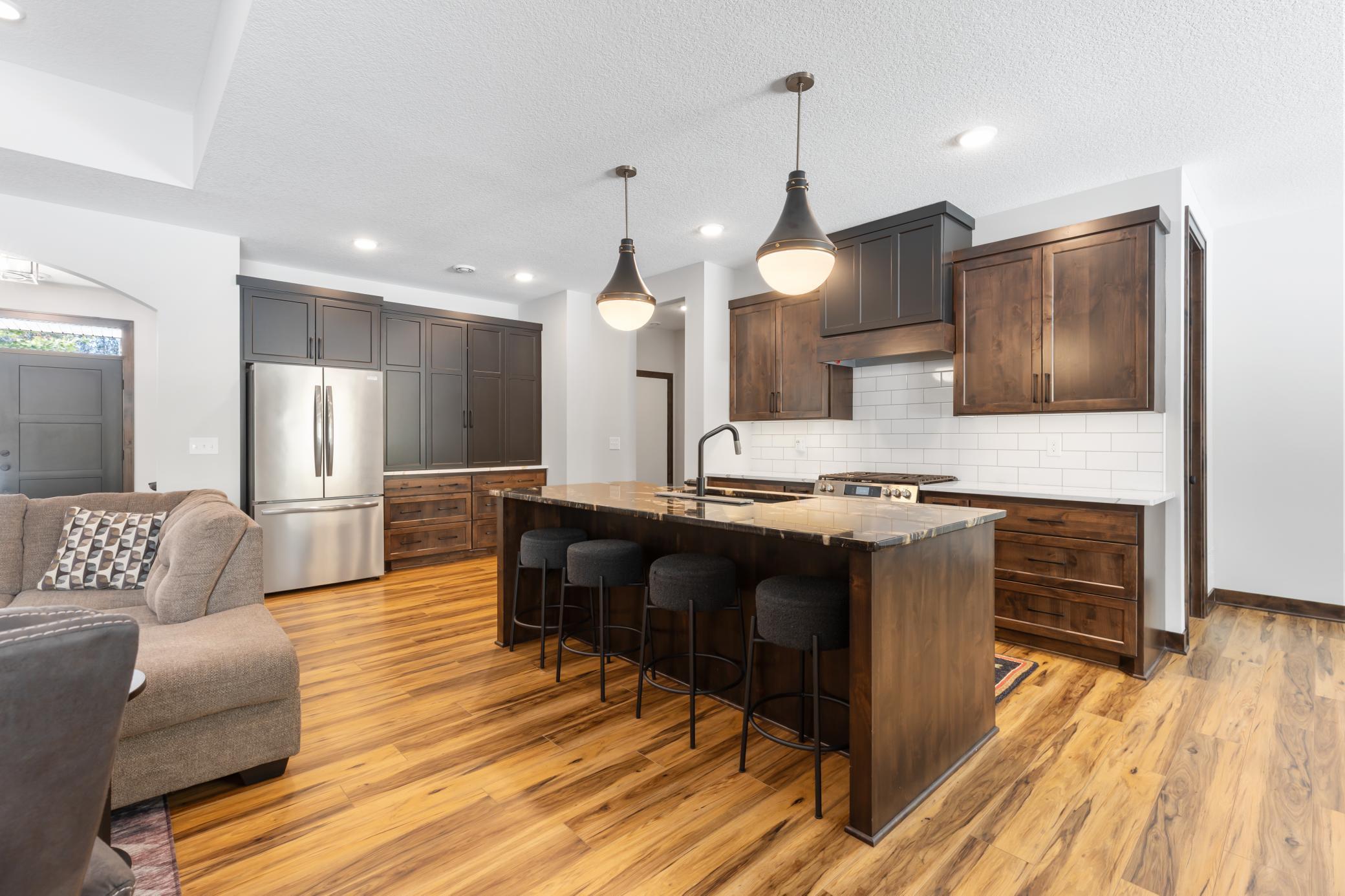 High-end fixtures, quality stainless steel appliances and seamless design allow this kitchen to shine as the heart of the home.