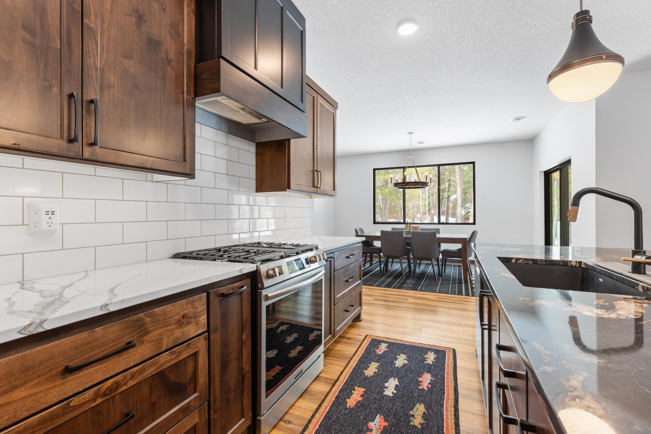 The intentional selections of natural wood finishes and stone flawlessly blend modern design with up-north living.