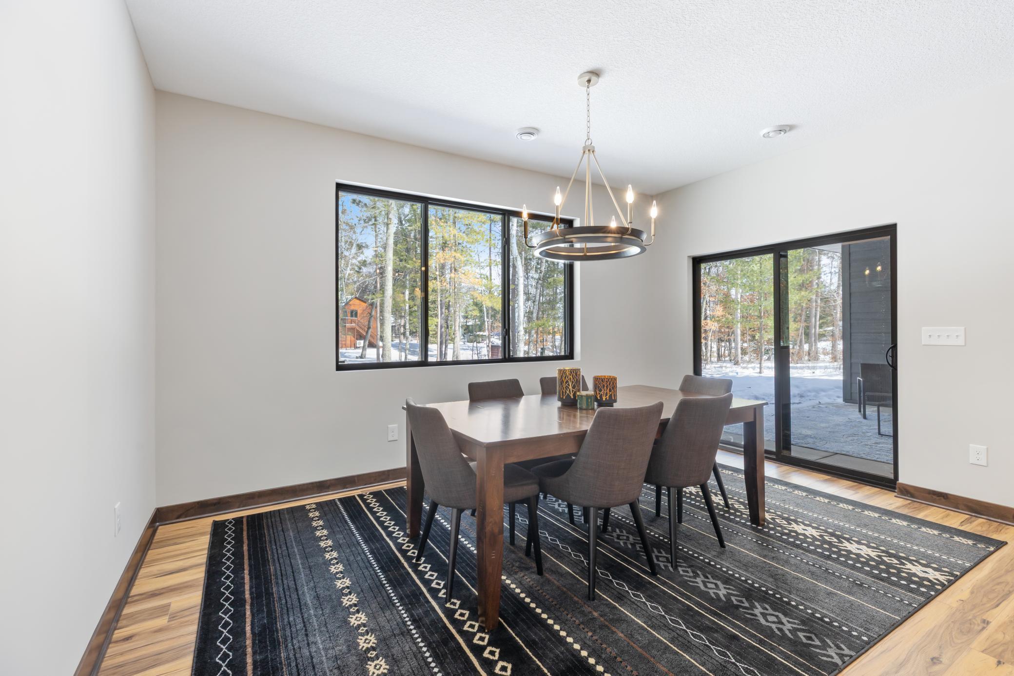 The immaculate dinning room overlooks a heavily wooded, private backyard and flows seamlessly to the covered back patio.