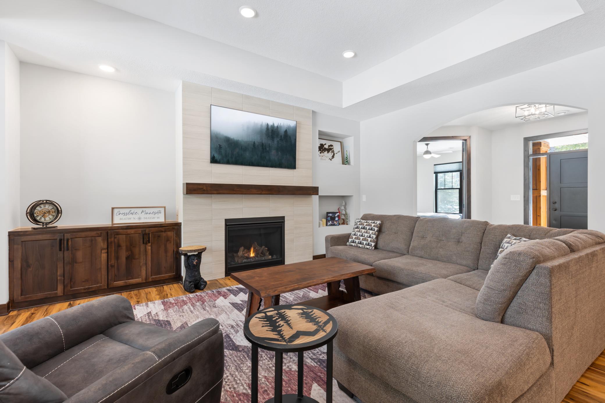 The stone wrapped, gas-burning fireplace creates a stunning centerpiece to enjoy in the living room.