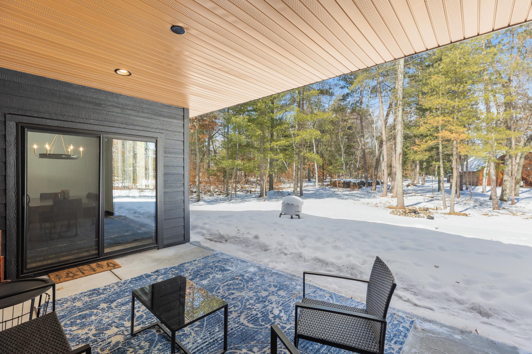 The dining space transitions effortlessly to the covered patio, blending indoor and outdoor living for elevated entertaining.