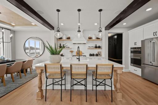 The kitchen is such a gathering place for todays households and this home delivers as the ideal place to host friends and guests alike. (model photo)