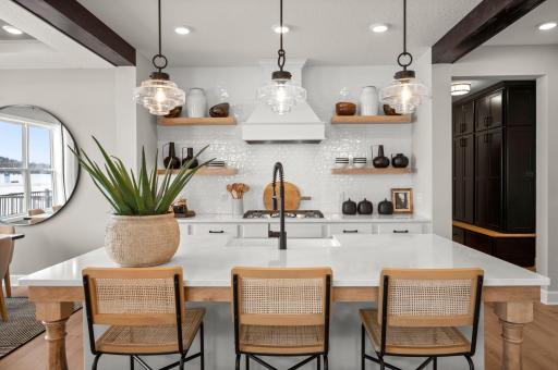 The kitchen is anchored by the large quartz kitchen island. (model photo)