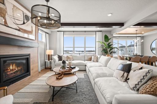 Another view of the great room, this space is perfect for hosting and entertaining but also a cozy space to enjoy a movie night by the fireplace. (model photo)